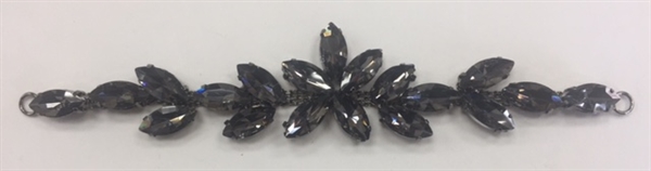 BKL-RHS-016-BLACK. Black Crystals on Black Metal Applique / Buckle - 6 X 1 Inches. Has hooks at booth ends. Very versatile accessory on garments and swim-suits.