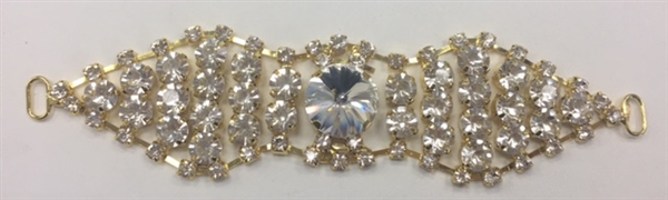 BKL-RHS-017-GOLD. Clear Crystals on Gold Metal Applique / Buckle - 5 X 1.2 Inches. Has hooks at booth ends. Very versatile accessory on garments and swim-suits.