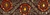TRM-IND-128-Burgundy.  2"-wide Handmaid Indian Trim - Dark Burgundy Background with Dark Gold Thread, Beads, Sequins and Orange Sequins and Stones.  Same as Style #124 but with smaller flowers.